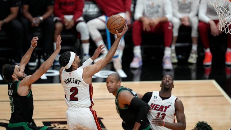 May 21, 2023; Miami, Florida, USA; Miami Heat guard Gabe Vincent (2) shoots against Boston Celtics guard Derrick White (9) during the second half in game three of the Eastern Conference Finals for the 2023 NBA playoffs at Kaseya Center. Mandatory Credit: Jim Rassol-USA TODAY Sports