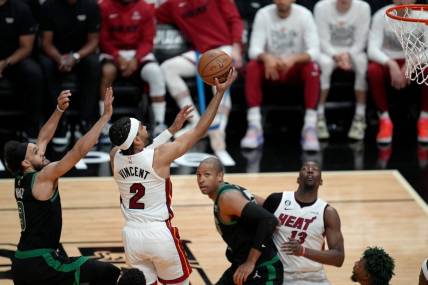 May 21, 2023; Miami, Florida, USA; Miami Heat guard Gabe Vincent (2) shoots against Boston Celtics guard Derrick White (9) during the second half in game three of the Eastern Conference Finals for the 2023 NBA playoffs at Kaseya Center. Mandatory Credit: Jim Rassol-USA TODAY Sports