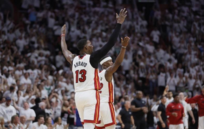 May 21, 2023; Miami, Florida, USA; Miami Heat center Bam Adebayo (13) and forward Jimmy Butler (22) react after a play during the third quarter against the Boston Celtics in game three of the Eastern Conference Finals for the 2023 NBA playoffs at Kaseya Center. Mandatory Credit: Sam Navarro-USA TODAY Sports