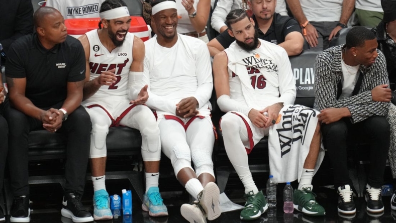 May 21, 2023; Miami, Florida, USA; Miami Heat guard Gabe Vincent (2), forward Jimmy Butler (22) and forward Caleb Martin (16) on the bench during the second half against the Boston Celtics in game three of the Eastern Conference Finals for the 2023 NBA playoffs at Kaseya Center. Mandatory Credit: Jim Rassol-USA TODAY Sports