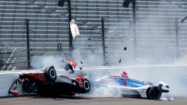 Rahal Letterman Lanigan Racing driver Katherine Legge (44) and Dreyer & Reinbold Racing driver Stefan Wilson (24) crash in the first turn Monday, May 22, 2023, during practice ahead of the 107th running of the Indianapolis 500 at Indianapolis Motor Speedway.