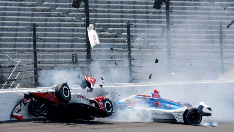 Rahal Letterman Lanigan Racing driver Katherine Legge (44) and Dreyer & Reinbold Racing driver Stefan Wilson (24) crash in the first turn Monday, May 22, 2023, during practice ahead of the 107th running of the Indianapolis 500 at Indianapolis Motor Speedway.