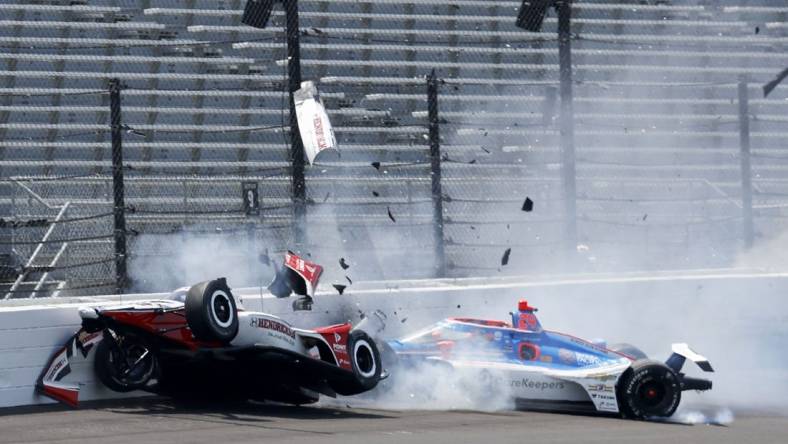 May 22, 2023; Speedway, Indiana, USA;Rahal Letterman Lanigan Racing driver Katherine Legge (44) and Dreyer & Reinbold Racing driver Stefan Wilson (24) crash in the first turn Monday, May 22, 2023, during practice ahead of the 107th running of the Indianapolis 500 at Indianapolis Motor Speedway. Mandatory Credit: John Chilton-USA TODAY Sports