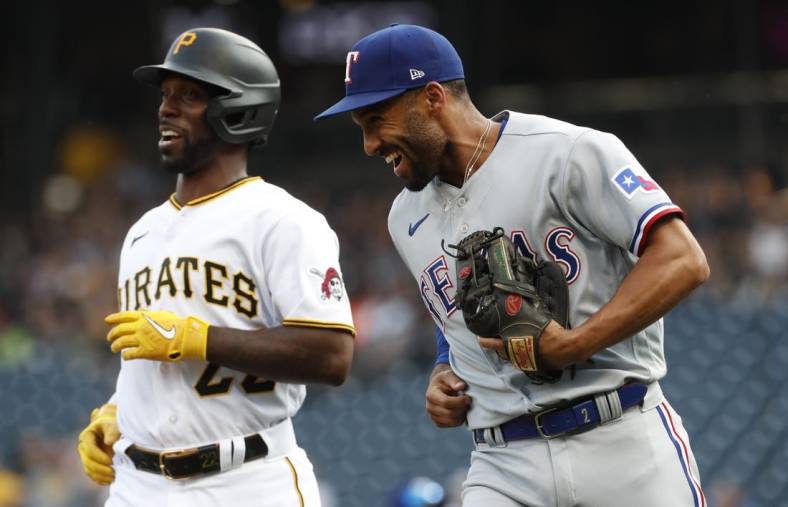 May 22, 2023; Pittsburgh, Pennsylvania, USA;  Texas Rangers second baseman Marcus Semien (right) and Pittsburgh Pirates designated hitter Andrew McCutchen (22) react after McCutchen was tagged out in a rundown between third base and home plate on a double steal attempt during the first inning at PNC Park. Mandatory Credit: Charles LeClaire-USA TODAY Sports