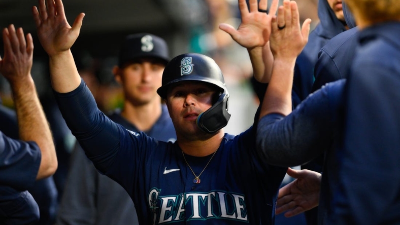May 22, 2023; Seattle, Washington, USA; Seattle Mariners first baseman Ty France (23) celebrates in the dugout after scoring a run off a single hit by third baseman Eugenio Suarez (28) during the sixth inning against the Oakland Athletics at T-Mobile Park. Mandatory Credit: Steven Bisig-USA TODAY Sports