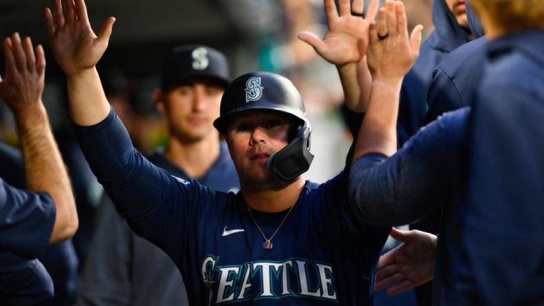 May 22, 2023; Seattle, Washington, USA; Seattle Mariners first baseman Ty France (23) celebrates in the dugout after scoring a run off a single hit by third baseman Eugenio Suarez (28) during the sixth inning against the Oakland Athletics at T-Mobile Park. Mandatory Credit: Steven Bisig-USA TODAY Sports