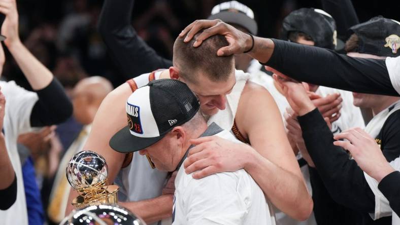 May 22, 2023; Los Angeles, California, USA; Denver Nuggets center Nikola Jokic (15) and head coach Michael Malone celebrate beating the Los Angeles Lakers in game four of the Western Conference Finals for the 2023 NBA playoffs at Crypto.com Arena. Mandatory Credit: Kirby Lee-USA TODAY Sports