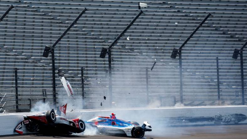 Rahal Letterman Lanigan Racing driver Katherine Legge (44) and Dreyer & Reinbold Racing driver Stefan Wilson (24) crash in the first turn Monday, May 22, 2023, during practice ahead of the 107th running of the Indianapolis 500 at Indianapolis Motor Speedway.