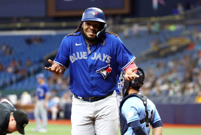 May 23, 2023; St. Petersburg, Florida, USA; Toronto Blue Jays first baseman Vladimir Guerrero Jr. (27) celebrates after he hit a grand slam against the Tampa Bay Rays during the ninth inning at Tropicana Field. Mandatory Credit: Kim Klement-USA TODAY Sports