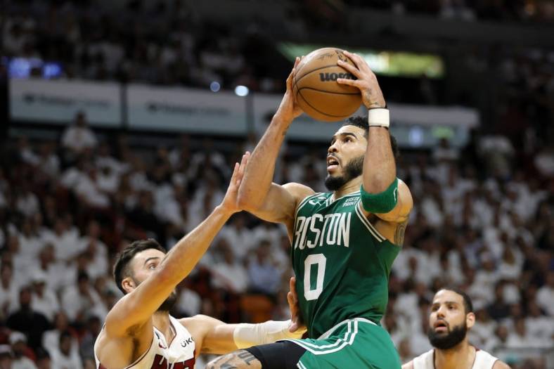 May 23, 2023; Miami, Florida, USA; Boston Celtics forward Jayson Tatum (0) shoots against Miami Heat guard Max Strus (31) in the third quarter during game four of the Eastern Conference Finals for the 2023 NBA playoffs at Kaseya Center. Mandatory Credit: Sam Navarro-USA TODAY Sports
