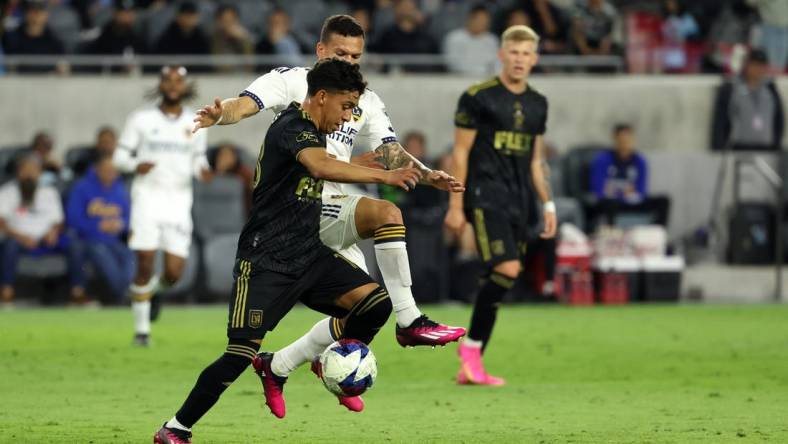 May 23, 2023; Los Angeles, CA, USA;  Los Angeles FC defender Erik Duenas (18) is fouled by Los Angeles Galaxy defender Calegari (2) during the first half of the the US Open Cup game at BMO Stadium. Mandatory Credit: Kiyoshi Mio-USA TODAY Sports