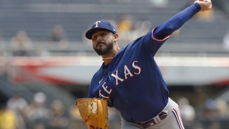 May 24, 2023; Pittsburgh, Pennsylvania, USA; Texas Rangers starting pitcher Martin Perez (54) delivers a pitch against the Pittsburgh Pirates during the first inning at PNC Park. Mandatory Credit: Charles LeClaire-USA TODAY Sports