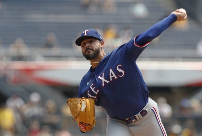 May 24, 2023; Pittsburgh, Pennsylvania, USA; Texas Rangers starting pitcher Martin Perez (54) delivers a pitch against the Pittsburgh Pirates during the first inning at PNC Park. Mandatory Credit: Charles LeClaire-USA TODAY Sports