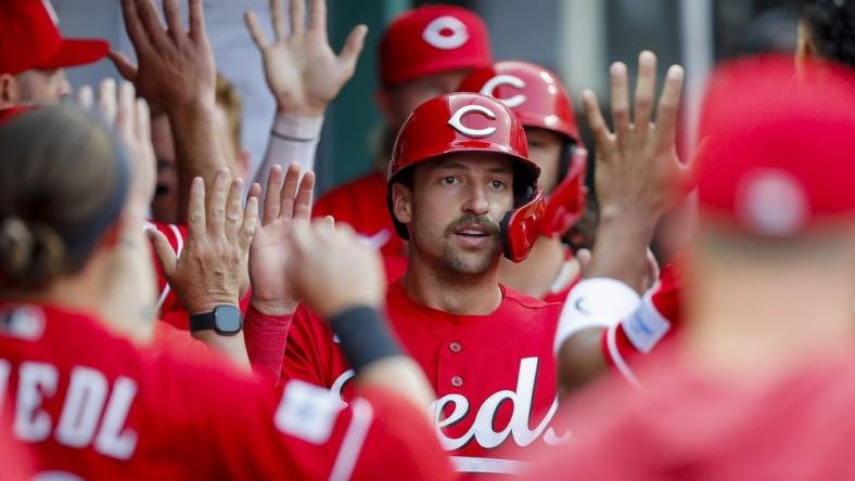 May 24, 2023; Cincinnati, Ohio, USA; Cincinnati Reds first baseman Spencer Steer (7) high fives teammates after scoring on a two-run single hit by catcher Tyler Stephenson (not pictured) in the first inning against the St. Louis Cardinals at Great American Ball Park. Mandatory Credit: Katie Stratman-USA TODAY Sports