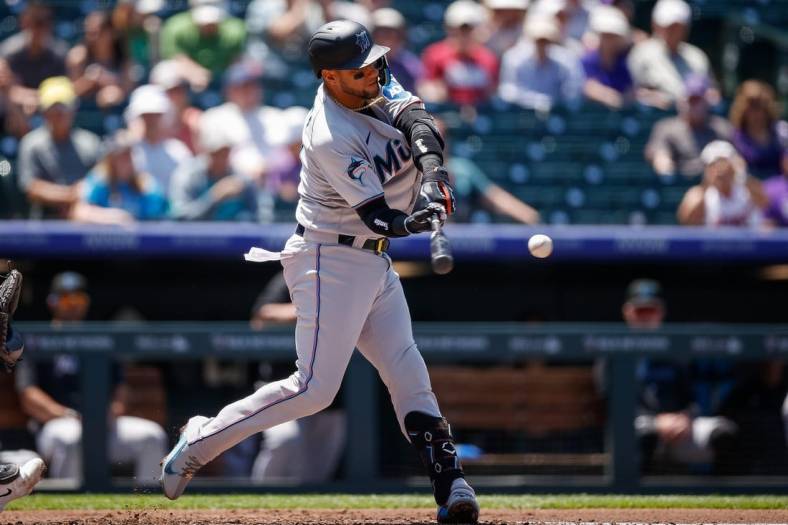 May 25, 2023; Denver, Colorado, USA; Miami Marlins first baseman Yuli Gurriel (10) this and RBI triple in the third inning against the Colorado Rockies at Coors Field. Mandatory Credit: Isaiah J. Downing-USA TODAY Sports