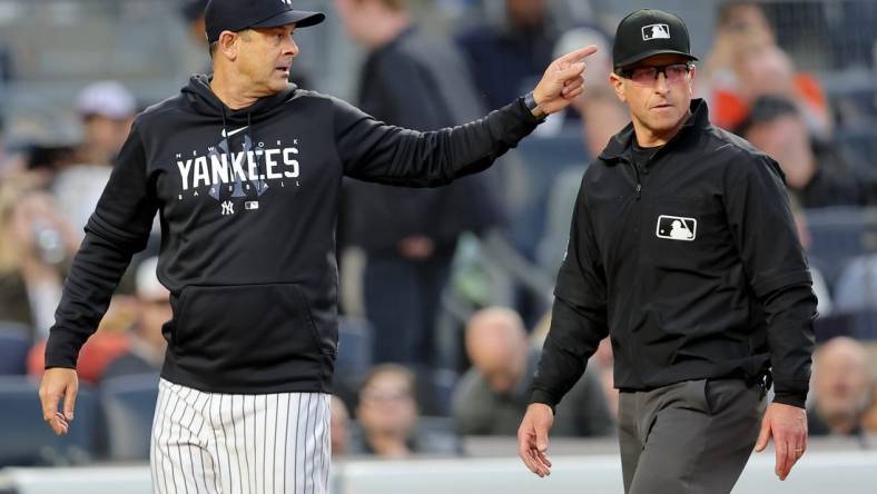 May 25, 2023; Bronx, New York, USA; New York Yankees manager Aaron Boone (17) argues with first base umpire Chris Guccione (68) during the third inning against the Baltimore Orioles at Yankee Stadium. Mandatory Credit: Brad Penner-USA TODAY Sports