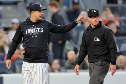 May 25, 2023; Bronx, New York, USA; New York Yankees manager Aaron Boone (17) argues with first base umpire Chris Guccione (68) during the third inning against the Baltimore Orioles at Yankee Stadium. Mandatory Credit: Brad Penner-USA TODAY Sports