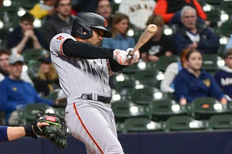 May 25, 2023; Milwaukee, Wisconsin, USA;  San Francisco Giants first baseman LaMonte Wade Jr. (31) hits an RBI single in the fifth inning against the Milwaukee Brewers at American Family Field. Mandatory Credit: Benny Sieu-USA TODAY Sports