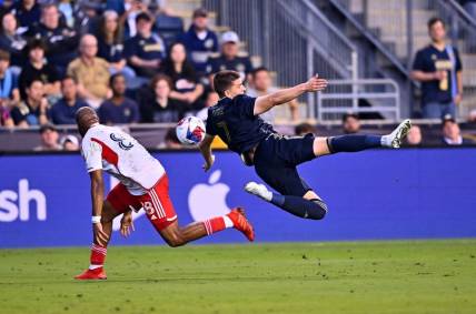 May 20, 2023; Philadelphia, Pennsylvania, USA; Philadelphia Union forward Mikkel Uhre (7) dives for the ball against New England Revolution defender Andrew Farrell (88) in the first half at Subaru Park. Mandatory Credit: Kyle Ross-USA TODAY Sports