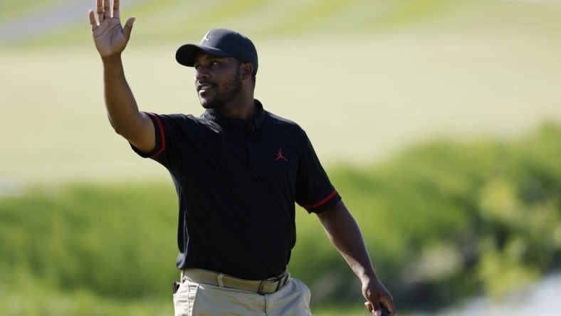 May 25, 2023; Washington, DC, USA; Harold Varner III waves to the crowd after making a birdie putt on the eighteenth hole during the first round of the LIV Golf DC 2023 tournament at Trump National Golf Club in Sterling, Va. Mandatory Credit: Geoff Burke-USA TODAY Sports