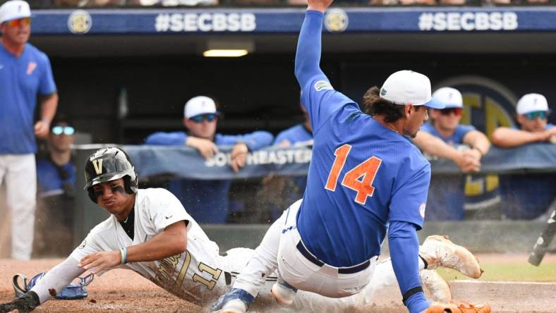 Vanderbilt base runner Davis Diaz scores on a pitch that got away from the catcher as Florida pitcher Jac Caglianone covers the plate Saturday, May 27, 2023, at the Hoover Met in the semifinal round.