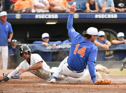 Vanderbilt base runner Davis Diaz scores on a pitch that got away from the catcher as Florida pitcher Jac Caglianone covers the plate Saturday, May 27, 2023, at the Hoover Met in the semifinal round.