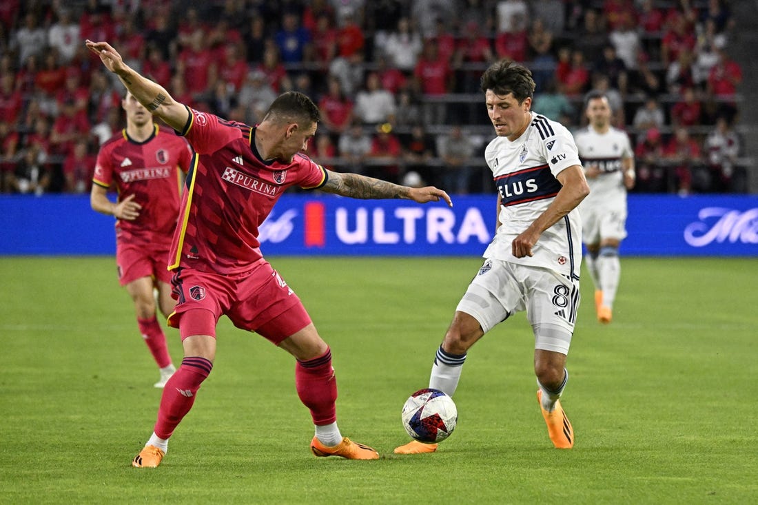 May 27, 2023; St. Louis, Missouri, USA; Vancouver Whitecaps midfielder Alessandro Schopf (8) dribbles the ball against St. Louis CITY SC defender Jake Nerwinski (2) during the first half at CITYPARK. Mandatory Credit: Scott Rovak-USA TODAY Sports