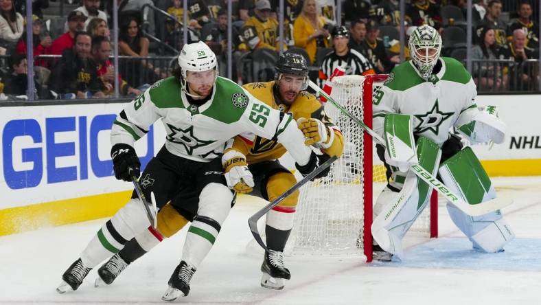 May 27, 2023; Las Vegas, Nevada, USA; Dallas Stars defenseman Thomas Harley (55) keeps the puck away from Vegas Golden Knights right wing Reilly Smith (19) during the second period in game five of the Western Conference Finals of the 2023 Stanley Cup Playoffs at T-Mobile Arena. Mandatory Credit: Stephen R. Sylvanie-USA TODAY Sports