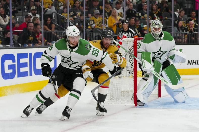 May 27, 2023; Las Vegas, Nevada, USA; Dallas Stars defenseman Thomas Harley (55) keeps the puck away from Vegas Golden Knights right wing Reilly Smith (19) during the second period in game five of the Western Conference Finals of the 2023 Stanley Cup Playoffs at T-Mobile Arena. Mandatory Credit: Stephen R. Sylvanie-USA TODAY Sports