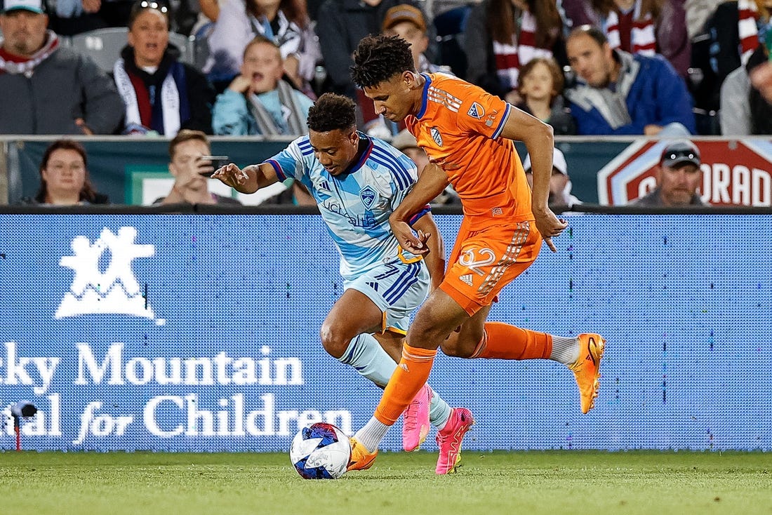 May 27, 2023; Commerce City, Colorado, USA; FC Cincinnati defender Ian Murphy (32) and Colorado Rapids forward Jonathan Lewis (7) battle for the ball in the first half at Dick's Sporting Goods Park. Mandatory Credit: Isaiah J. Downing-USA TODAY Sports