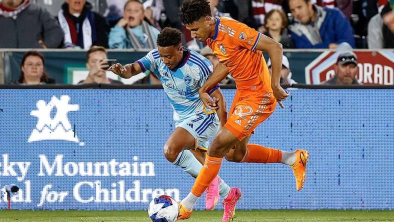 May 27, 2023; Commerce City, Colorado, USA; FC Cincinnati defender Ian Murphy (32) and Colorado Rapids forward Jonathan Lewis (7) battle for the ball in the first half at Dick's Sporting Goods Park. Mandatory Credit: Isaiah J. Downing-USA TODAY Sports