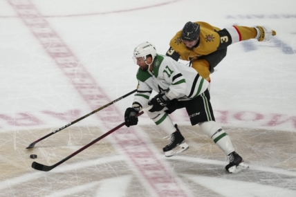 May 27, 2023; Las Vegas, Nevada, USA; Dallas Stars center Luke Glendening (11) skates with the puck past Vegas Golden Knights defenseman Brayden McNabb (3) during the third period in game five of the Western Conference Finals of the 2023 Stanley Cup Playoffs at T-Mobile Arena. Mandatory Credit: Stephen R. Sylvanie-USA TODAY Sports