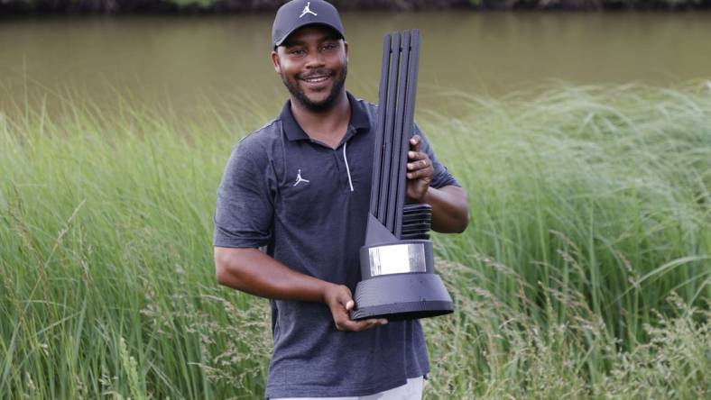 May 28, 2023; Potomac Falls, Virginia, USA; Harold Varner III poses with the champions trophy after winning the individual championship of LIV Golf Washington, D.C. golf tournament at Trump National. Mandatory Credit: Geoff Burke-USA TODAY Sports