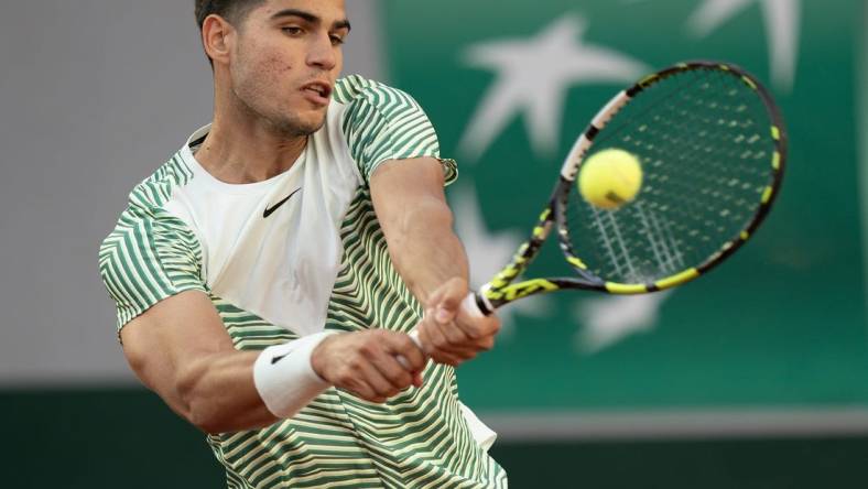 May 29, 2023; Paris,France; Carlos Alcaraz (ESP) returns a shot during his match against Flavio Cobolli (ITA) on day two at Stade Roland-Garros. Mandatory Credit: Susan Mullane-USA TODAY Sports