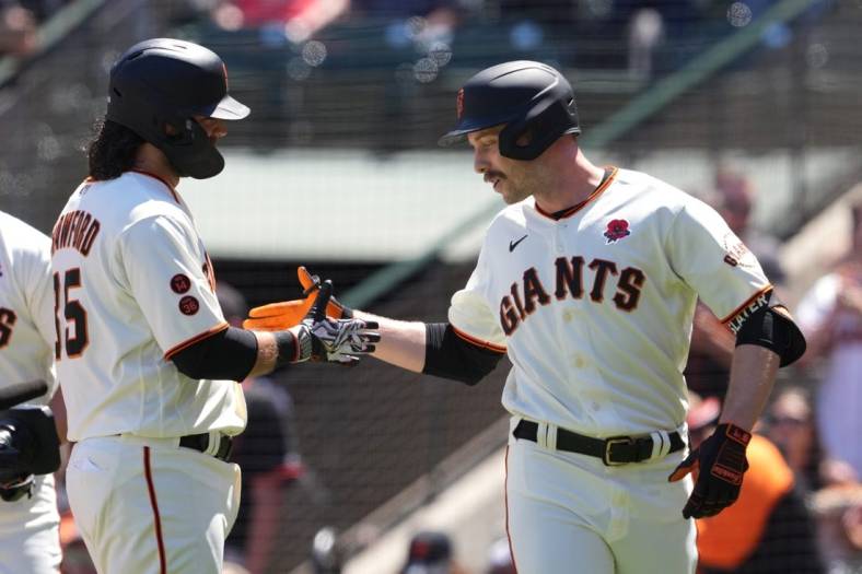 May 29, 2023; San Francisco, California, USA; San Francisco Giants left fielder Austin Slater (right) celebrates with shortstop Brandon Crawford (left) after hitting a home run against the Pittsburgh Pirates during the second inning at Oracle Park. Mandatory Credit: Darren Yamashita-USA TODAY Sports