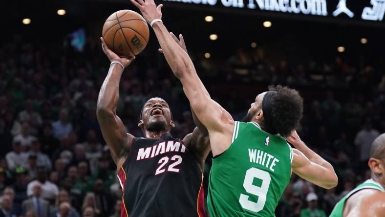 May 29, 2023; Boston, Massachusetts, USA; Miami Heat forward Jimmy Butler (22) shoots against Boston Celtics guard Derrick White (9) in the second quarter during game seven of the Eastern Conference Finals for the 2023 NBA playoffs at TD Garden. Mandatory Credit: David Butler II-USA TODAY Sports