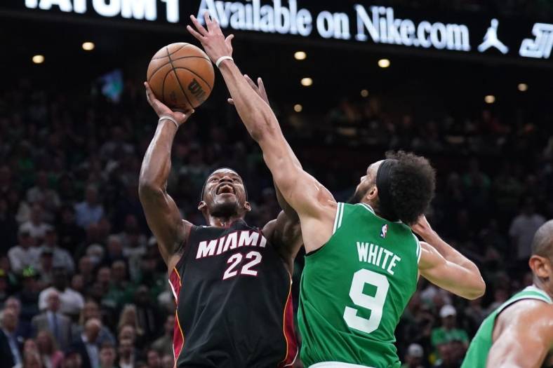 May 29, 2023; Boston, Massachusetts, USA; Miami Heat forward Jimmy Butler (22) shoots against Boston Celtics guard Derrick White (9) in the second quarter during game seven of the Eastern Conference Finals for the 2023 NBA playoffs at TD Garden. Mandatory Credit: David Butler II-USA TODAY Sports