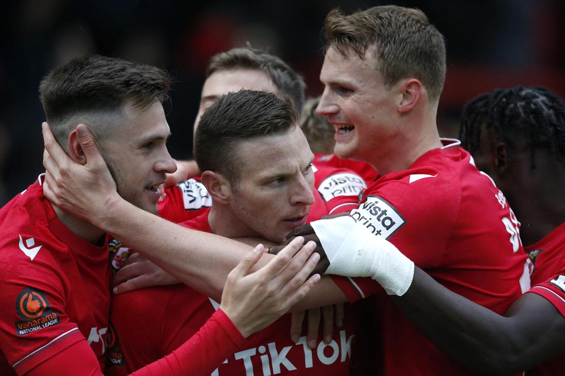 Wrexham's Paul Mullin celebrates scoring their second goal with teammates against Boreham Wood at the Racecourse Ground, Wrexham, Britain - April 22, 2023