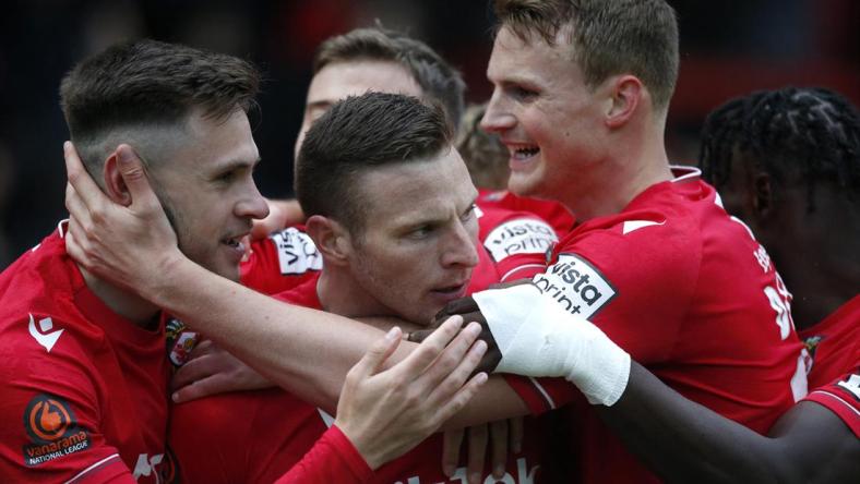 Wrexham's Paul Mullin celebrates scoring their second goal with teammates against Boreham Wood at the Racecourse Ground, Wrexham, Britain - April 22, 2023