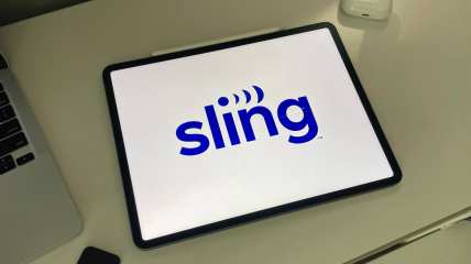Sling TV logo on an Ipad next to a laptop