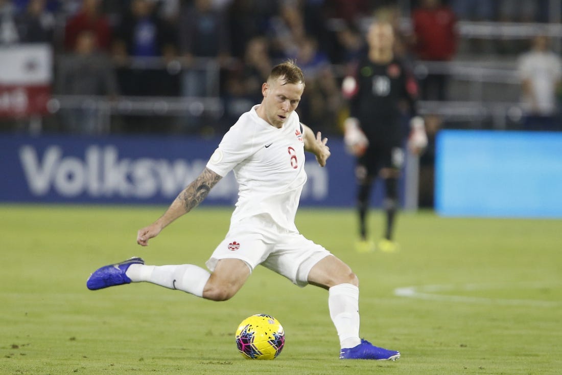 Nov 15, 2019; Orlando, FL, USA; Canada midfielder Scott Arfield (8) kicks the ball against the the United States during the first half of a CONCACAF Nations League soccer match at Exploria Stadium. Mandatory Credit: Reinhold Matay-USA TODAY Sports