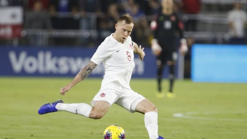 Nov 15, 2019; Orlando, FL, USA; Canada midfielder Scott Arfield (8) kicks the ball against the the United States during the first half of a CONCACAF Nations League soccer match at Exploria Stadium. Mandatory Credit: Reinhold Matay-USA TODAY Sports