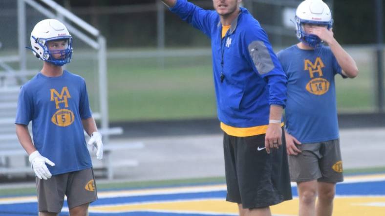 Mountain Home assistant coach Ryan Mallett gives instructions during a recent practice as Bombers Dillon Drewry (left) and Daxton Hickman (right) listen at Bomber Stadium. Fans must buy tickets in advance to attend the Bombers' scrimmage on Thursday against Highland. No tickets will be sold at the gate.

Dsc 6234