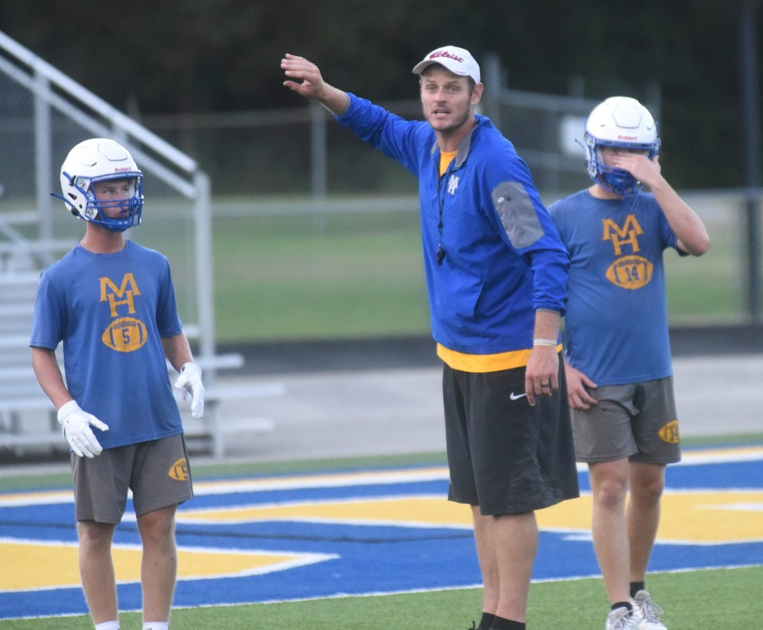 Mountain Home assistant coach Ryan Mallett gives instructions during a recent practice as Bombers Dillon Drewry (left) and Daxton Hickman (right) listen at Bomber Stadium. Fans must buy tickets in advance to attend the Bombers' scrimmage on Thursday against Highland. No tickets will be sold at the gate.

Dsc 6234