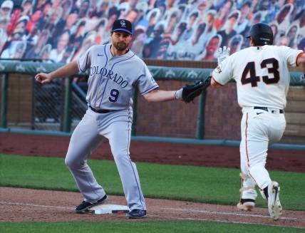 Sep 24, 2020; San Francisco, California, USA; Colorado Rockies first baseman Daniel Murphy (9) makes an out to retire San Francisco Giants catcher Tyler Heineman (43) during the eleventh inning at Oracle Park. Mandatory Credit: Kelley L Cox-USA TODAY Sports