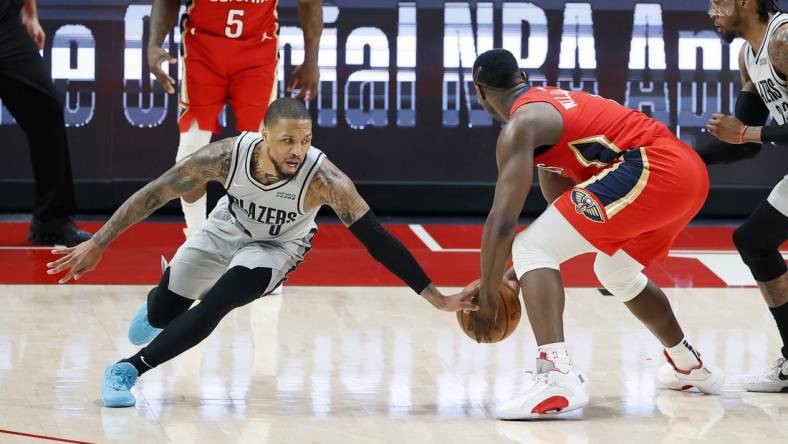 Trade chatter before Thursday's NBA draft connects Portland Trail Blazers point guard Damian Lillard (left) with New Orleans Pelicans power forward Zion Williamson. Mandatory Credit: Soobum Im-USA TODAY Sports