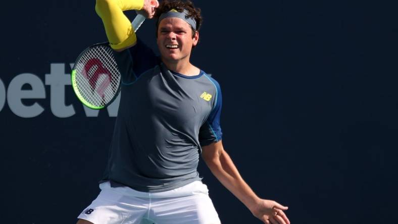 Mar 30, 2021; Miami, Florida, USA; Milos Raonic of Canada hits a forehand against Hubert Hurkacz of Poland (not pictured) in the fourth round in the Miami Open at Hard Rock Stadium. Mandatory Credit: Geoff Burke-USA TODAY Sports