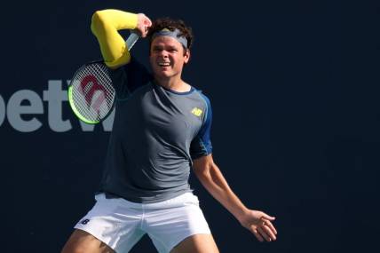 Mar 30, 2021; Miami, Florida, USA; Milos Raonic of Canada hits a forehand against Hubert Hurkacz of Poland (not pictured) in the fourth round in the Miami Open at Hard Rock Stadium. Mandatory Credit: Geoff Burke-USA TODAY Sports