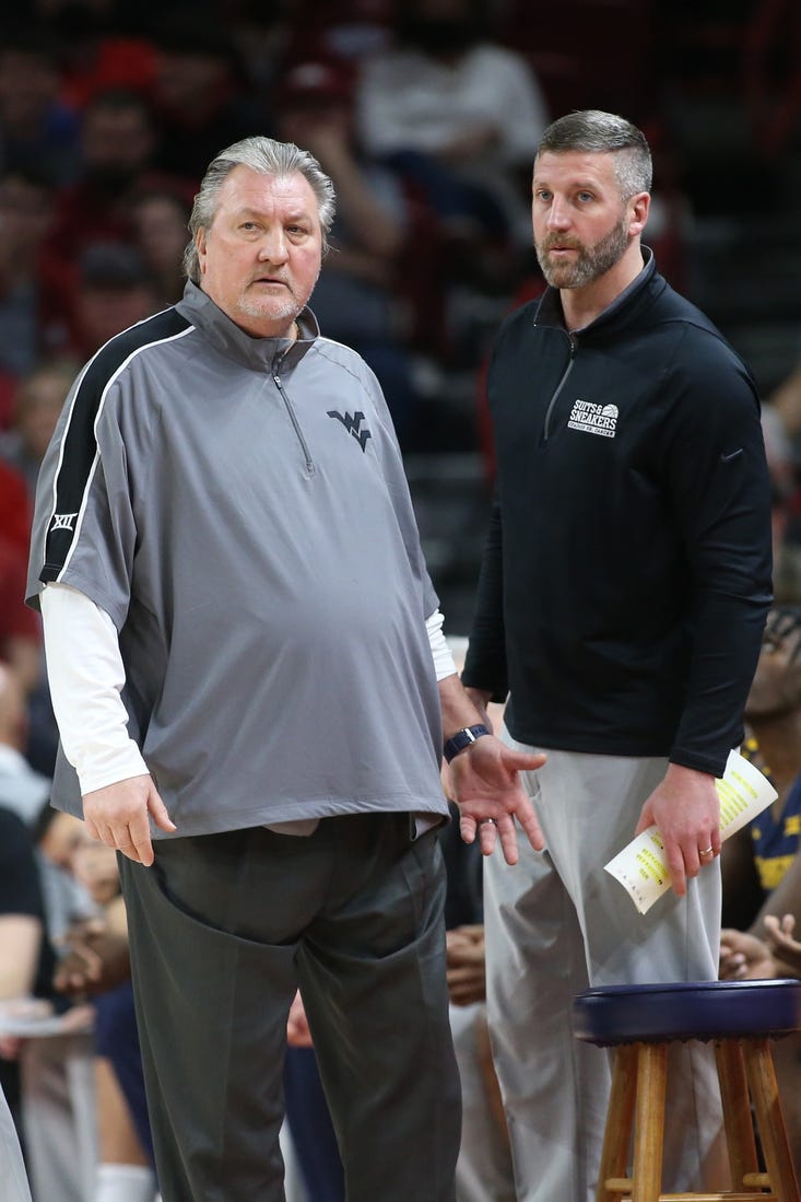 Jan 29, 2022; Fayetteville, Arkansas, USA; West Virginia Mountaineers head coach Bob Huggins and director of basketball operations Josh Eilert during the game against the Arkansas Razorbacks at Bud Walton Arena. Arkansas won 77-68. Mandatory Credit: Nelson Chenault-USA TODAY Sports