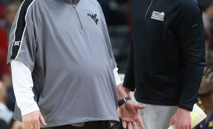 Jan 29, 2022; Fayetteville, Arkansas, USA; West Virginia Mountaineers head coach Bob Huggins and director of basketball operations Josh Eilert during the game against the Arkansas Razorbacks at Bud Walton Arena. Arkansas won 77-68. Mandatory Credit: Nelson Chenault-USA TODAY Sports